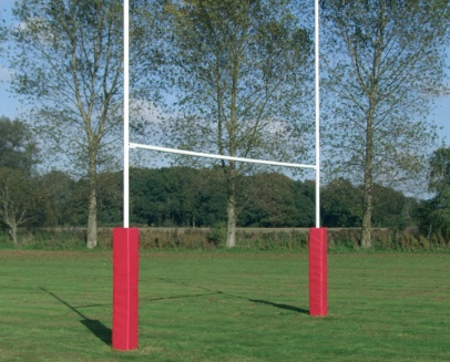 GT Rugby Posts 10m Standard Mild Steel 5 | Synsport Rugby goalposts with red safety pads on a grassy field and trees in the background.
