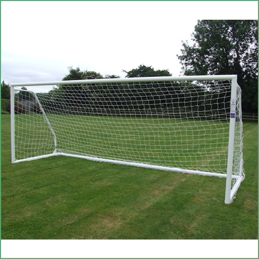 Synsport sports equipment - 9v9 soccer goals free standing units 2 | Synsport White soccer goal with netting placed on a grassy field, trees in the background, empty and ready for play.