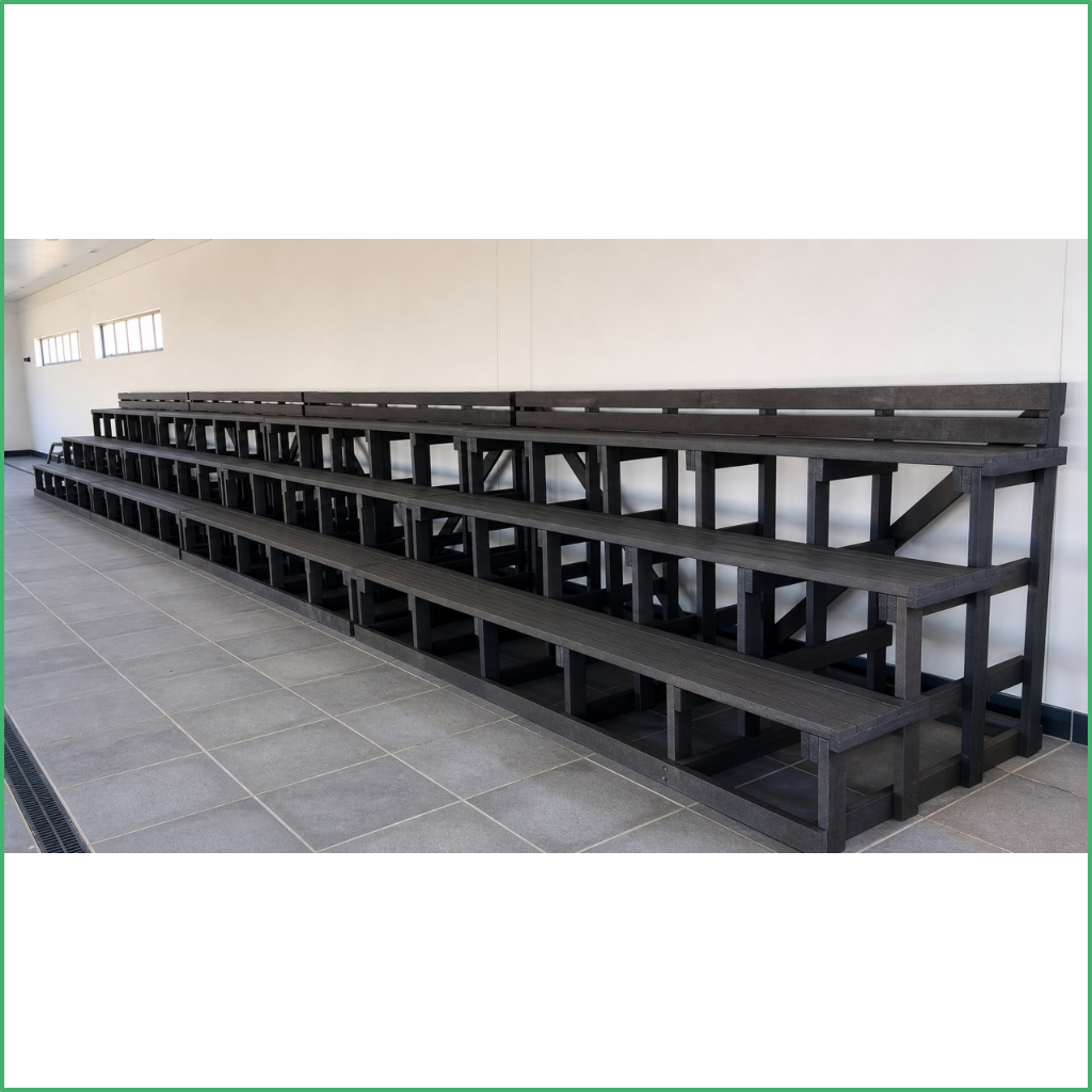 Synsport sports equipment - Recycled plastic seating | Synsport Black wooden bleachers with three levels along a pale wall in an empty room.
