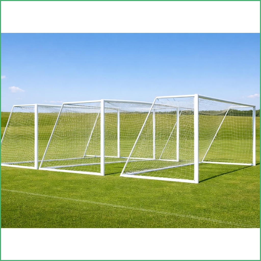Synsport sports equipment - mid-size Soccer goal Aluminium 1 | Synsport Row of white soccer goals arranged on a grassy field under a blue sky and few clouds.